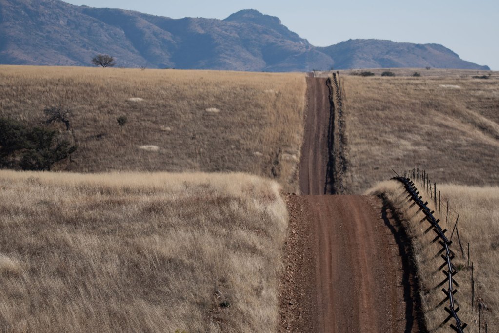 Vehicle barriers line a frontage road along the U.S.-Mexico border in Arizona in this file photo from December 2021. Photo by Isaac Stone Simonelli | AZCIR